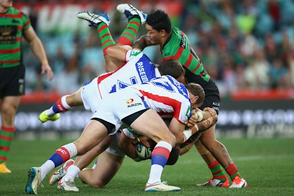 Headed for turf: Dylan Walker of the Rabbitohs is upended in a dangerous looking tackle.