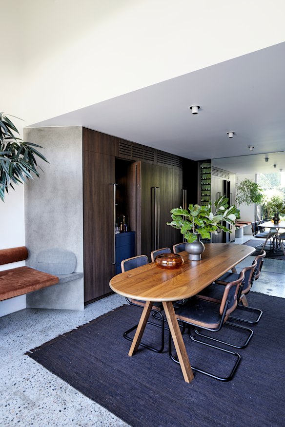 Ben says the dining area, his favourite space, displays “a moody material palette of rich, dark timbers alongside exposed concrete and bronze architectural hardware”.