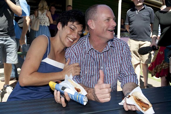 Campbell and Lisa Newman enjoy a sausage sizzle after casting their votes. Photo: Harrison Saragossi