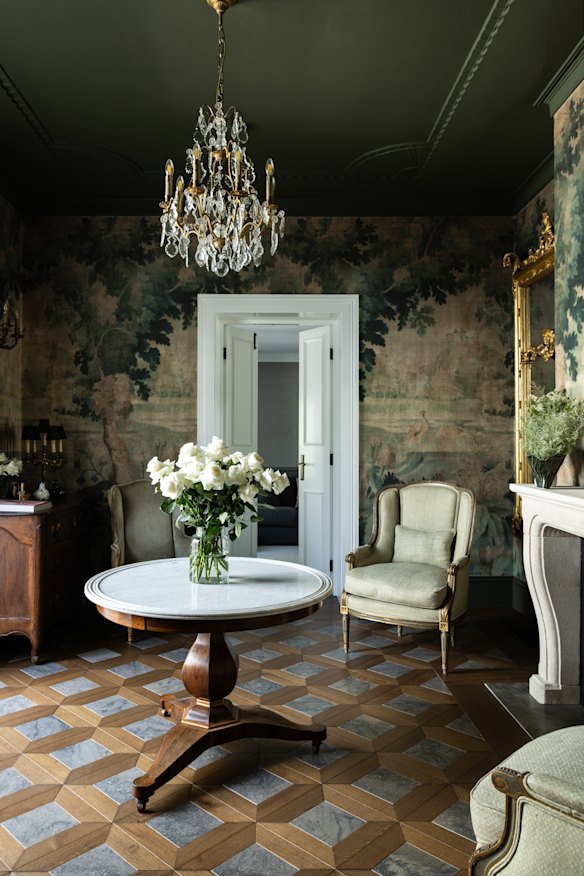 Wallpaper and parquetry floors put a firm stamp on this space designed by Woods & Warner.