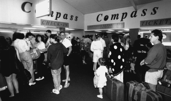 Passengers wait at Sydney Airport last night. December 18, 1991.