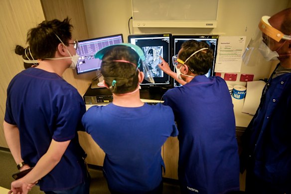 Doctors inspecting X-rays from a COVID-19 patient.