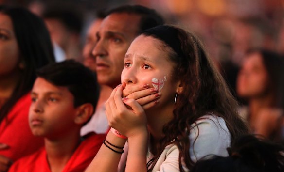 An England soccer fan reacts after England lost the semifinal match between Croatia and England at the 2018 soccer World Cup, in Hyde Park, London.