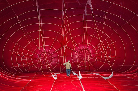 A man inspects the inside of a hot air ballon at festivities at Parramatta Park.