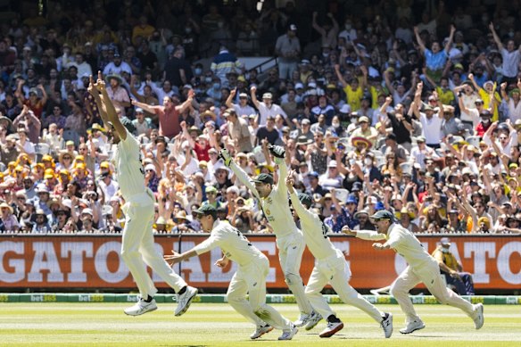 The Australian team celebrate a win at the Melbourne Cricket Ground.