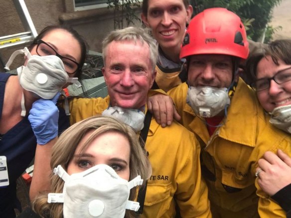 Tamara Ferguson, front, takes a selfie in front of a Paradise, California, house with a group trapped by flames: nurse Chardonnay Telly, left, firefighters Matt Arness and Joe Greco, EMT Shannon Molarius and Dr David Russell, back. 