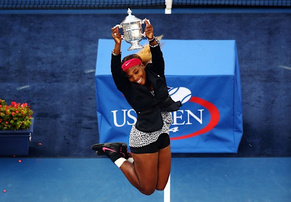2014 US Open - Serena Williams celebrates with the trophy after defeating Caroline Wozniacki of Denmark.