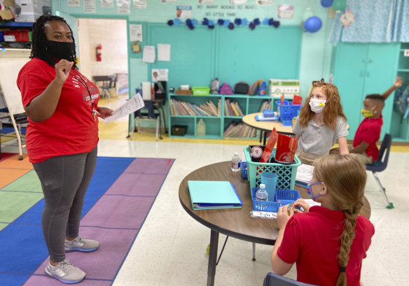 Primary school students at Northeast Lauderdale Elementary in the US, where students are required to wear masks.