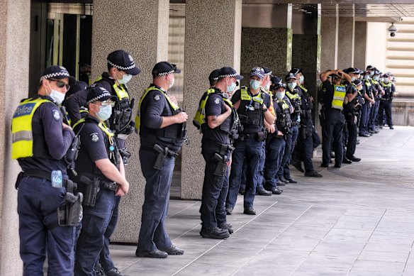 Police stand guard outside number 1 treasury place during Eureka freedom rally in Melbourne.