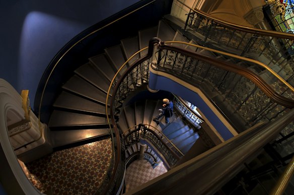 The stairs within Queen Victoria Building are quiet with only a few shops open. 