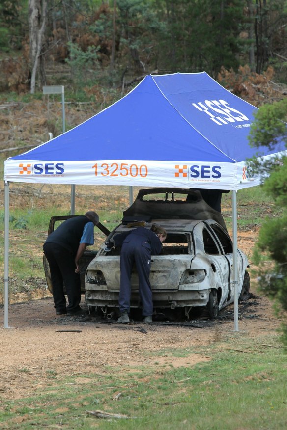 Police examine Ms Chetcuti's burnt-out car.