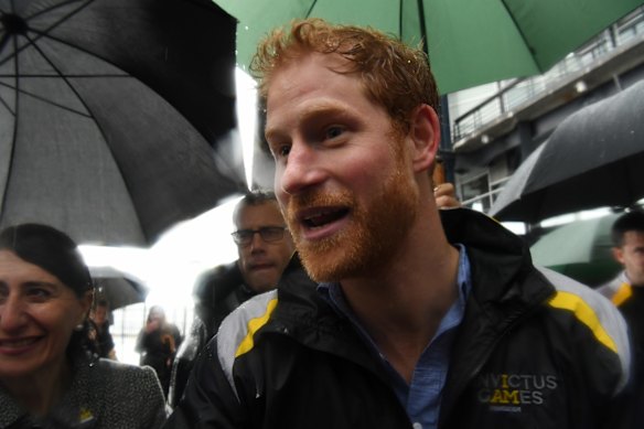 Prince Harry meets crowds at Campbell Cove, Circular Quay in very wet weather on June 7, 2017 in Sydney, Australia.