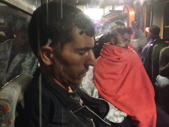 Migrants board buses said to be bound for Austria outside Keleti station in central Budapest, Hungary.