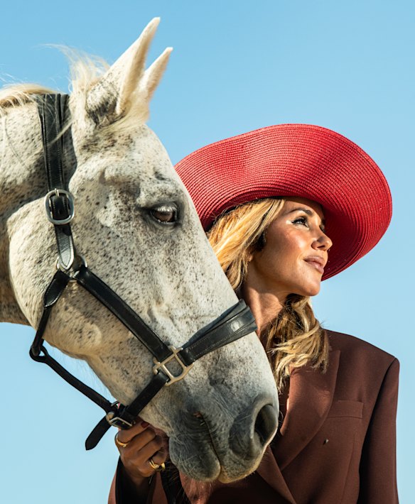 Edwards wears an Acne Studios suit and Ford Millinery hat. 