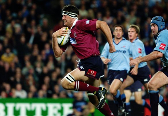 Big game player: John Eales bursts through the NSW defense in 2001.