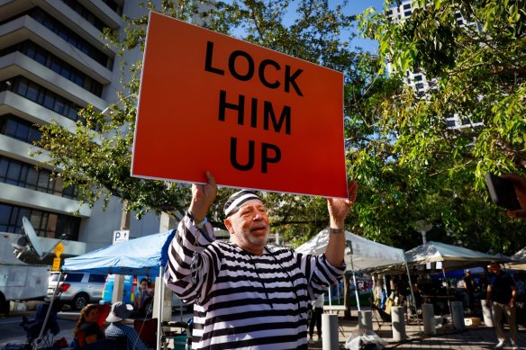A protestor holds a “Lock Him Up” sign outside the Wilkie D. Ferguson Jr. United States Courthouse in Miami, Florida,