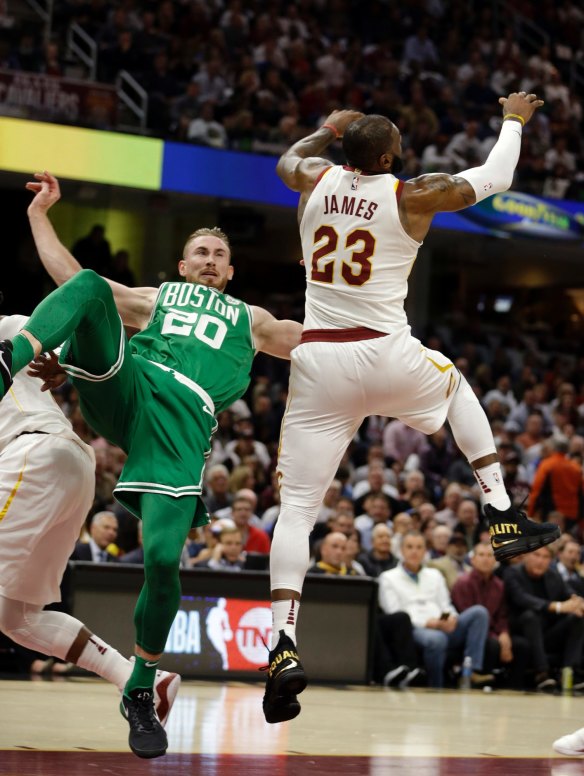 Boston Celtics' Gordon Hayward falls as Cavaliers' LeBron James reaches for a loose ball. 