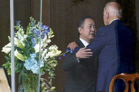 President Joe Biden talks with Japanese ambassador to the United States, Koji Tomita, after signing a condolence book at the Japanese ambassador's residence in Washington.