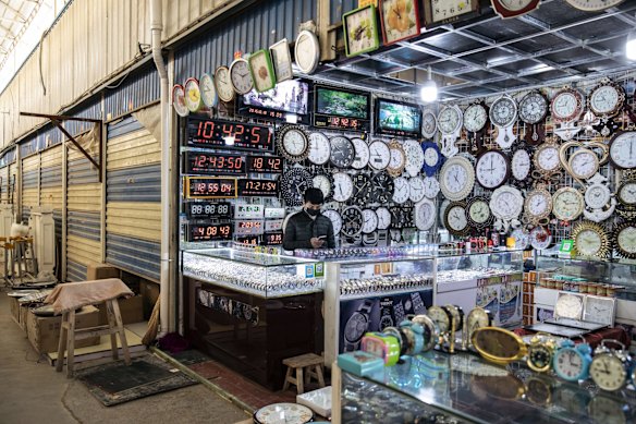 Clocks are displayed at a stall inside the main bazaar in Kashgar, Xinjiang autonomous region, China.