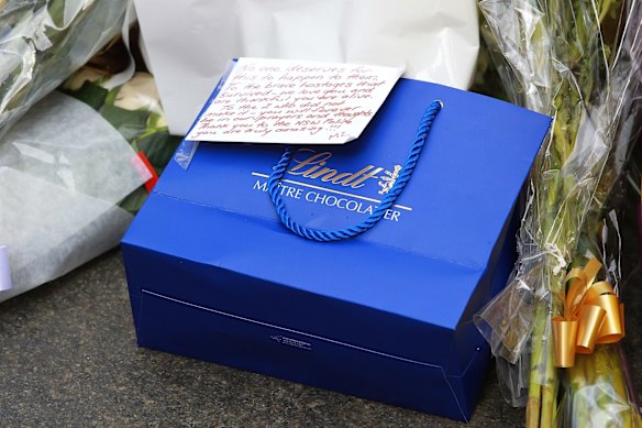 Members of the public left flowers, Lindt chocolates and messages of support in Martin Place on Tuesday. 