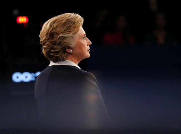 Democratic presidential nominee Hillary Clinton watches as Republican presidential nominee Donald Trump speaks during the second presidential debate.
