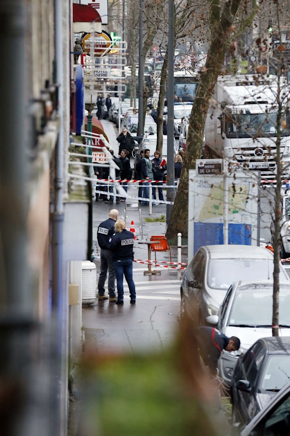Police, paramedics and firefighters at the scene of the shooting in the south Paris on Thursday, January 8. 