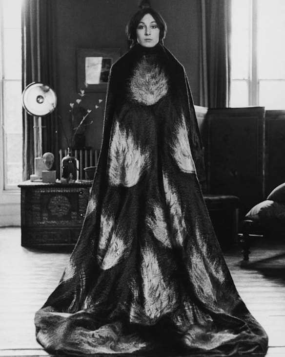 American actress Anjelica Huston wearing a floor length cape decorated with a flame motif, early 1970s. (Photo by Terry O'Neill/Getty Images)