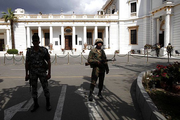 Members of the Egyptian army stand guard at the Parliament building during anti-government protests in Cairo.