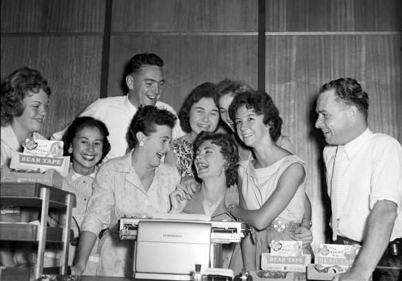 Australian athlete Marlene Mathews, celebrates her record with colleagues at the Bear Tape company on March 21, 1958.