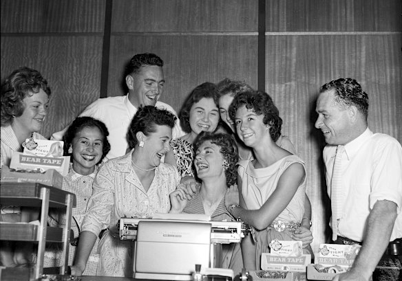 Australian athlete Marlene Mathews, celebrates her record with colleagues at the Bear Tape company on March 21, 1958.