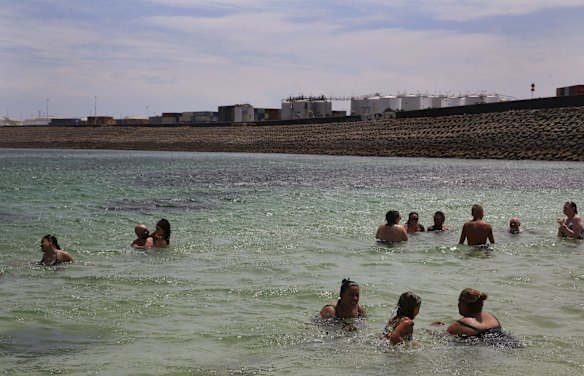 Crowds find refuge from the oppressive heat, swimming at Yarra Bay.