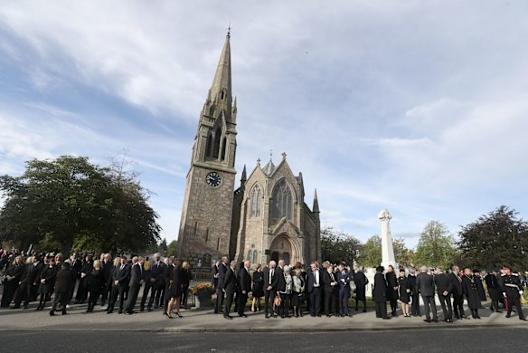Members of the public line the streets in Ballater, Scotland, as they wait for the hearse carrying the coffin of Queen Elizabeth II to makes its journey to Edinburgh from Balmoral in Scotland.