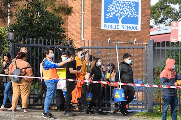 Cleaners leave South Coogee Public School, after deep cleaning it due to Covid-19 cases at the School.