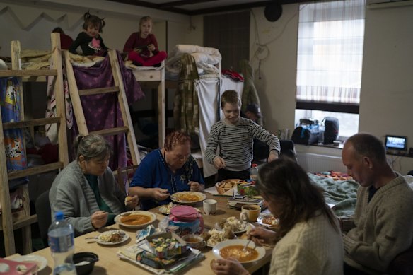 Displaced people have lunch cooked by volunteers at a restaurant that was transformed into a shelter for those who are fleeing the war from eastern region of the country, in Dnipro. The UN refugee agency says more than 5 million refugees have fled Ukraine since Russian troops invaded the country.