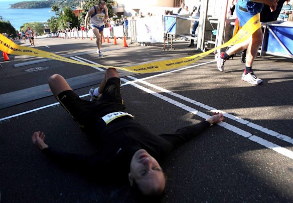 The Humpty Dumpty Foundation's Balmoral Burn run. Todd Devery, winner of the Male/female aged 50-59, crawls under the finishing banner.
