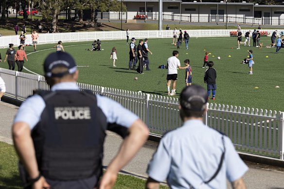 Police patrol Gore Hill Oval in St Leonards as people exercise during COVID lockdown.