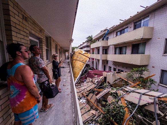 Residents assess damage caused by debris in Dee Why, where roofs were ripped off during the “microburst” , a severe storm downdraft often with winds exceeding 100kph.  