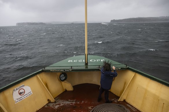 A child endures wild weather aboard the Manly Ferry in 2021.