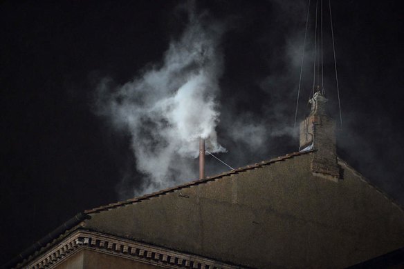 White smoke rises from the chimney on the roof of the Sistine Chapel meaning that cardinals elected a new pope on the second day.
