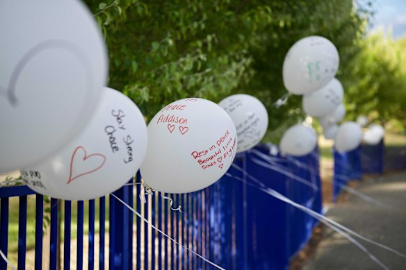 Mourners kept pouring into Hillcrest Primary School on Saturday morning, laying flowers on the lawn and tying white balloons emblazoned with heartfelt messages to the school’s fence.