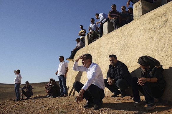 Turkish and Syrian Kurds gathered to witness the ongoing fight between Islamic State militants and Kurdish YPG fighters, visible not far over the border in Syria.
