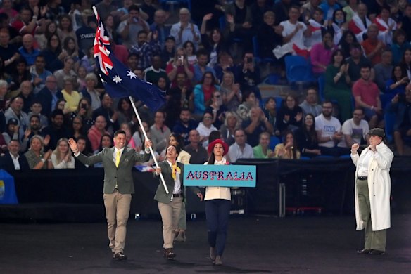 Flag bearers Eddie Ockenden and Rachael Grinham lead the team for the ceremony.