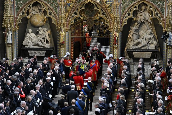 Queen Elizabeth’s coffin is carried into Westminster Abbey.