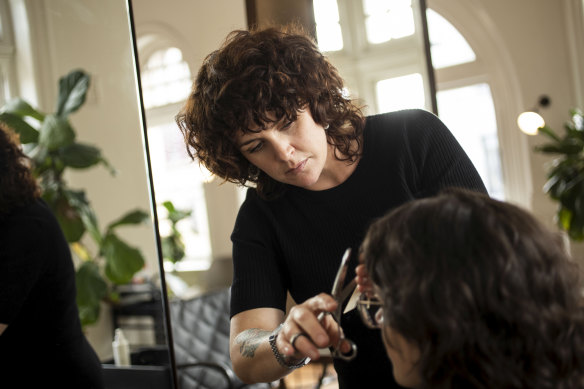 “It’s crazy,” says hairstylist Kate De Pasquale, pictured at A + H salon, in Sydney’s Newtown, about the strict rules of the Curly Girl Method; flouting them, she says, has got her kicked off a CGM Facebook group.