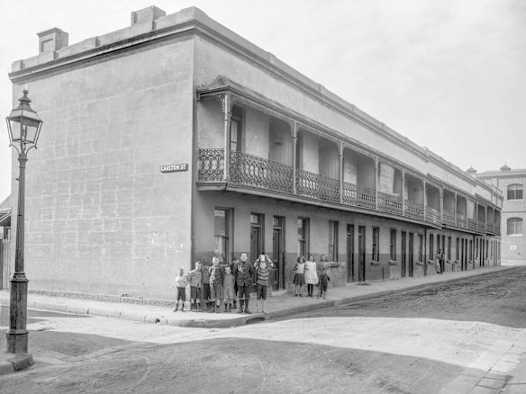 18-44 Irving Street, Chippendale, 1908. View east along Irving Street, looking towards Tooth's Brewery buildings on Balfour Street. This row of 12 terraces, on the corner of Carlton Street, was eventually swallowed up by the brewery. Children were part of the street life of Chippendale. A nearby landlord complained that it was a terrible street and that children were always dirtying and chalking on her house.