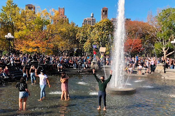 Jubilant scenes: New Yorkers danced in a fountain in Washington Square Park. 