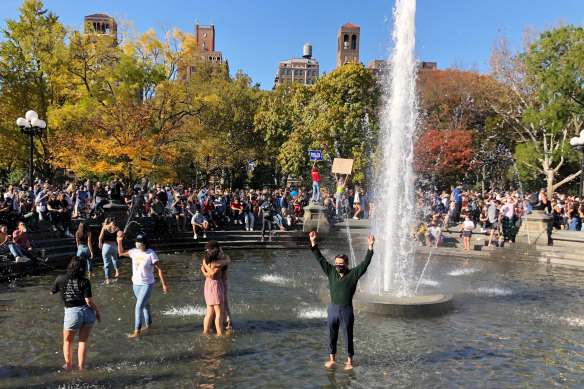 Jubilant scenes: New Yorkers danced in a fountain in Washington Square Park. 