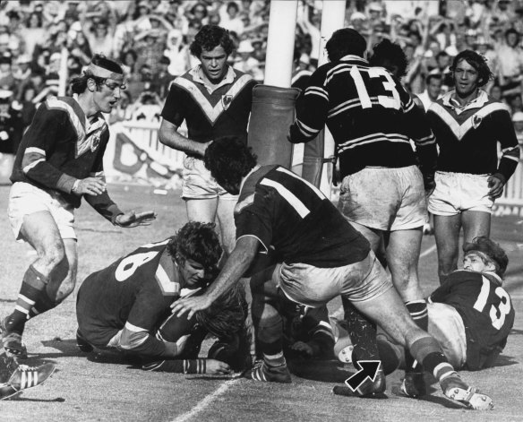 Was it a try? Manly skipper Freddie Jones is hurled back from the tryline by Easts forwards Laurie Freier and Arthur Beetson (11), while the ball (arrowed) remains over the line. 