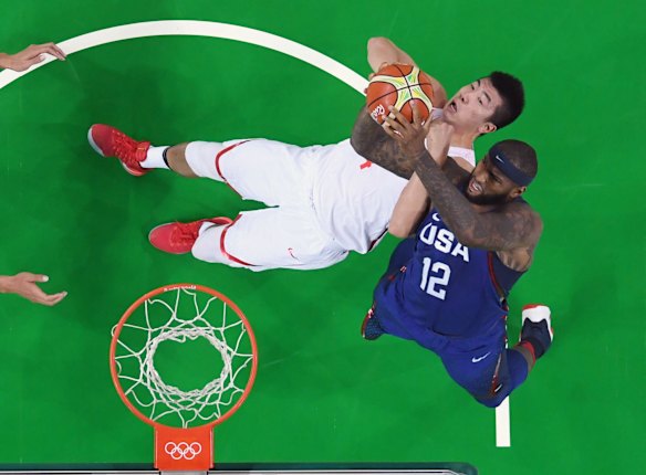 China's Zou Yuchen and United States centre DeMarcus Cousins compete for a rebound during their men's basketball game.