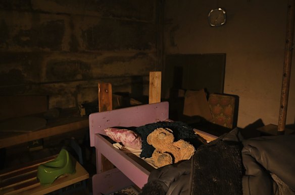 A teddy bear lies on child's bunk bed in a school basement in Yahidne where 371 people from the village were imprisoned by occupying Russian forces. 